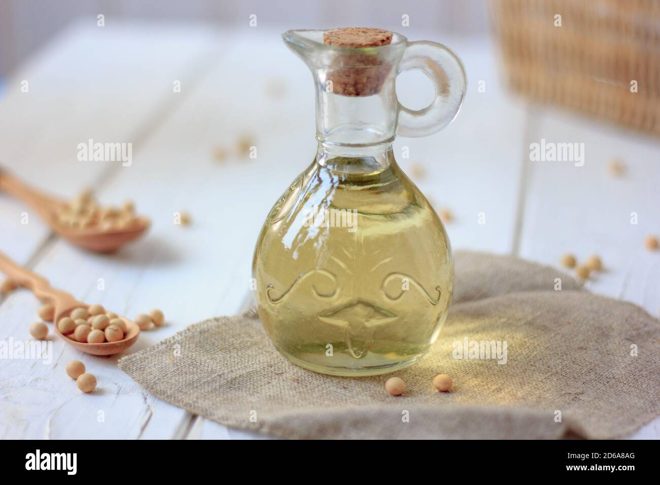 Natural and organic soybean oil with soy beans around it Stock Photo
