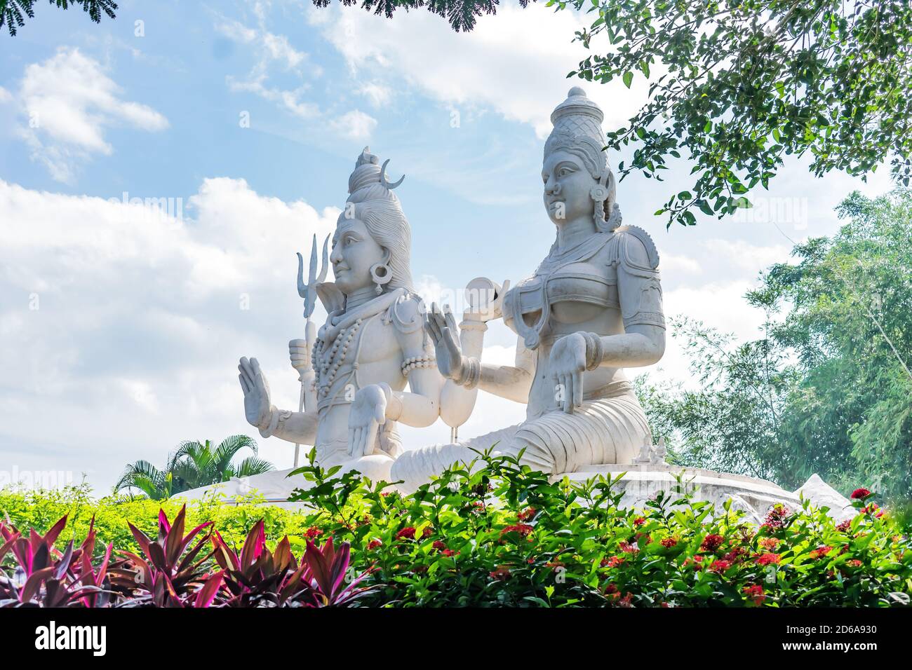 lord shiv & parvati statue at an indian garden looking awesome with small shrubs. Stock Photo