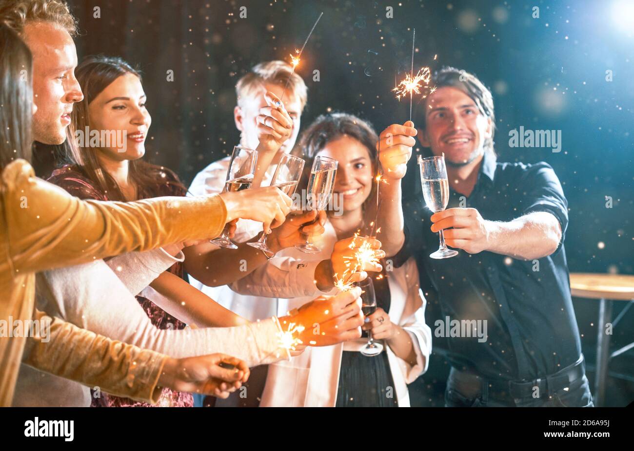 Group of cheerful young people have party and celebrating new year indoors Stock Photo