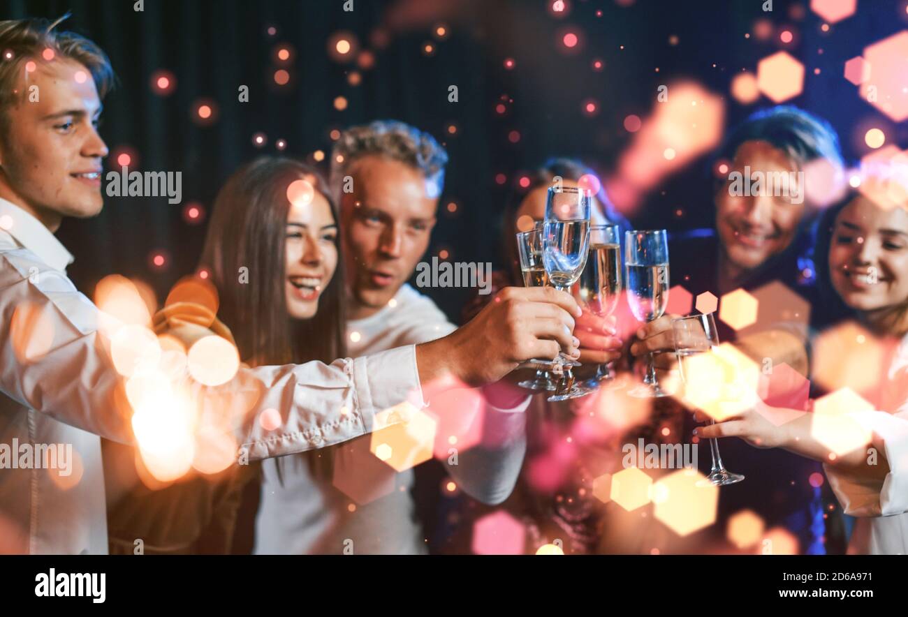 Group of cheerful young people have party and celebrating new year indoors Stock Photo