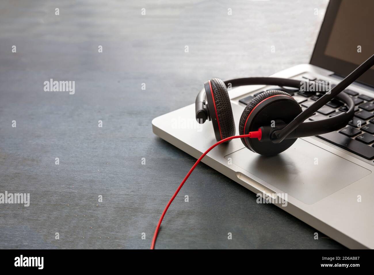 Call center and home office concept. Customer service support, help desk, communication. Headset and laptop on blue wooden desk, closeup view, copy sp Stock Photo