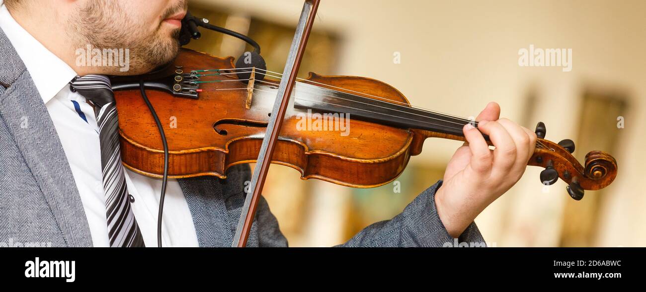 Playing violin, a musician plays vintage violin on a concert, close up Stock Photo