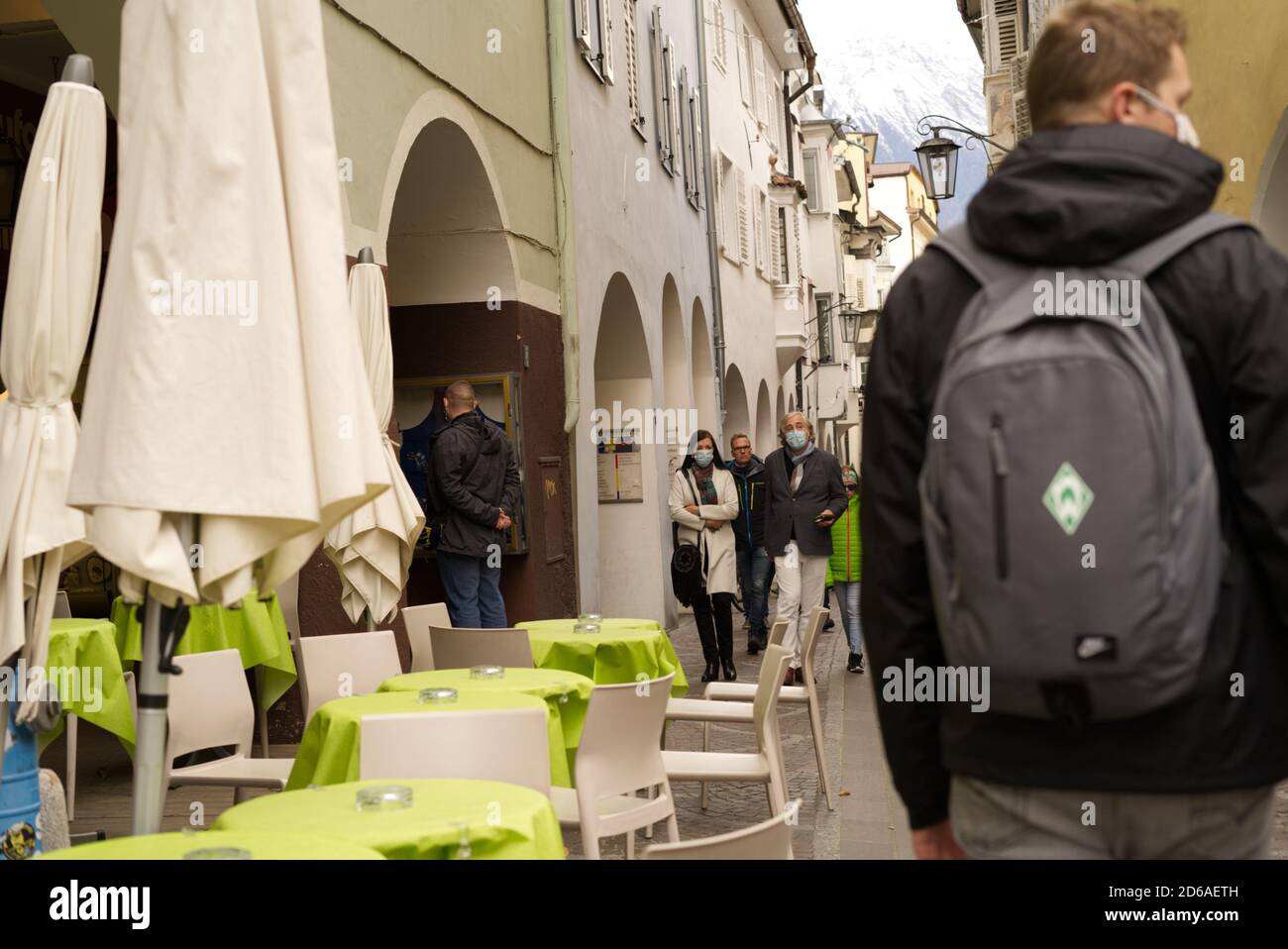 Famous shopping street in Merano, South Tirol, Italy with people walking by and wearing face protection masks on October 15th, 2020. Stock Photo
