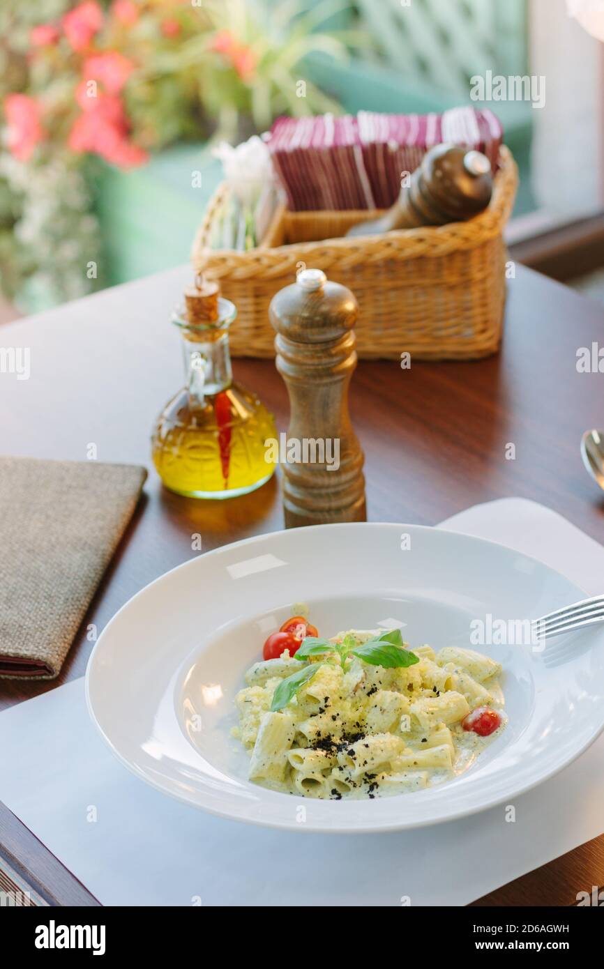 Italian food rigatoni pasta with basil and black truffle Stock Photo