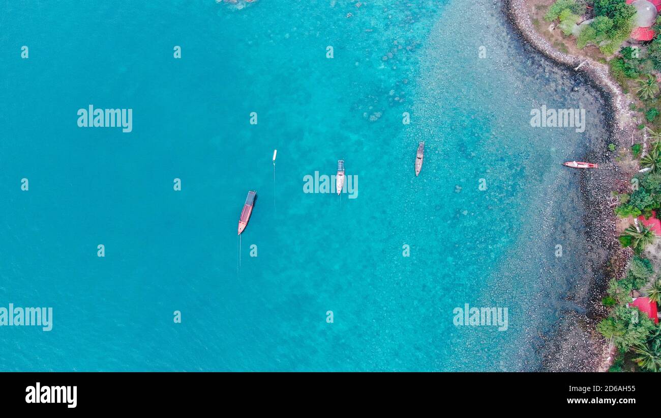 Aerial shot of boats in a turquoise ocean near the shore Stock Photo ...