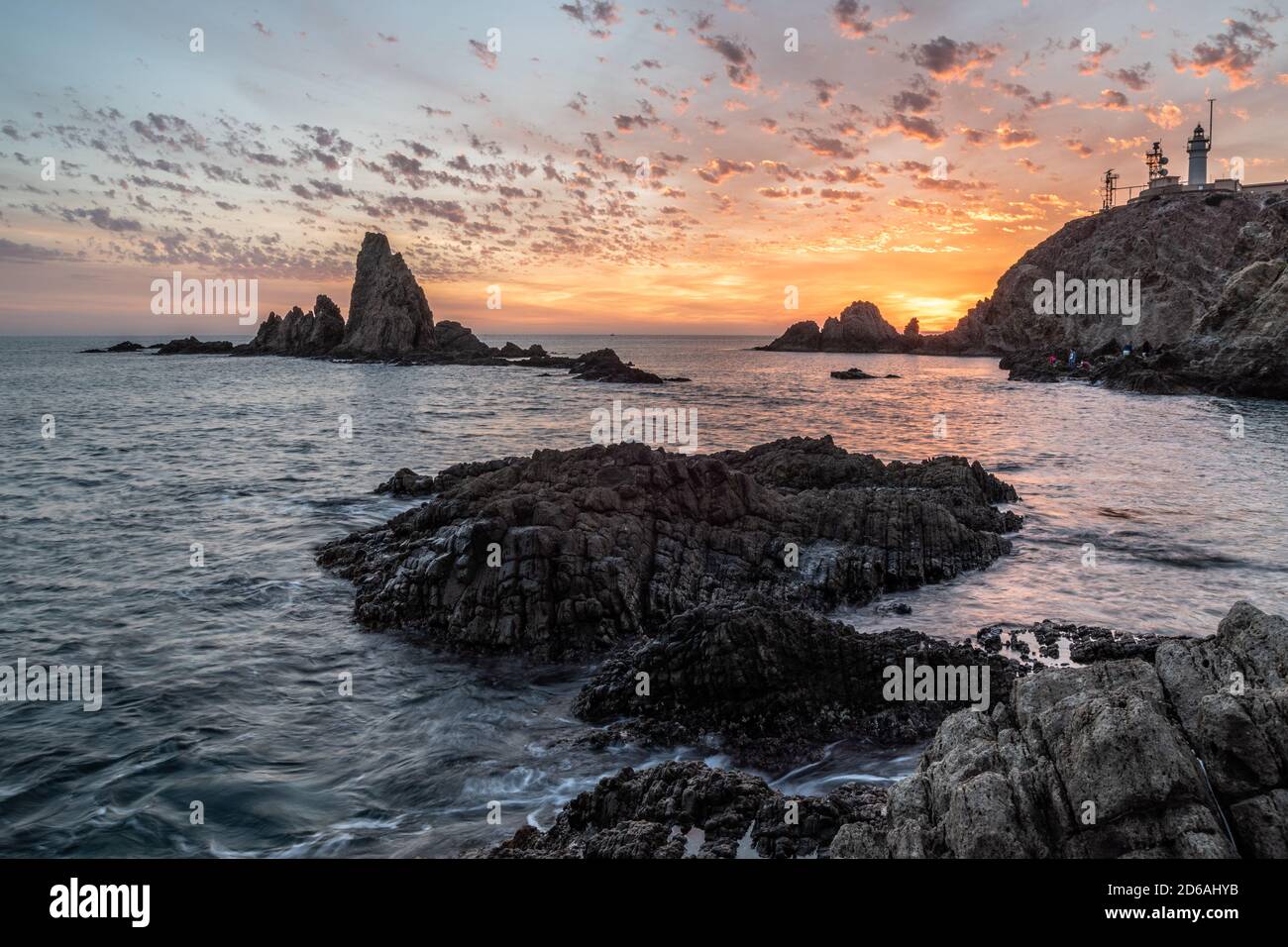 Nice sunset on a coast full of big rocks Stock Photo - Alamy
