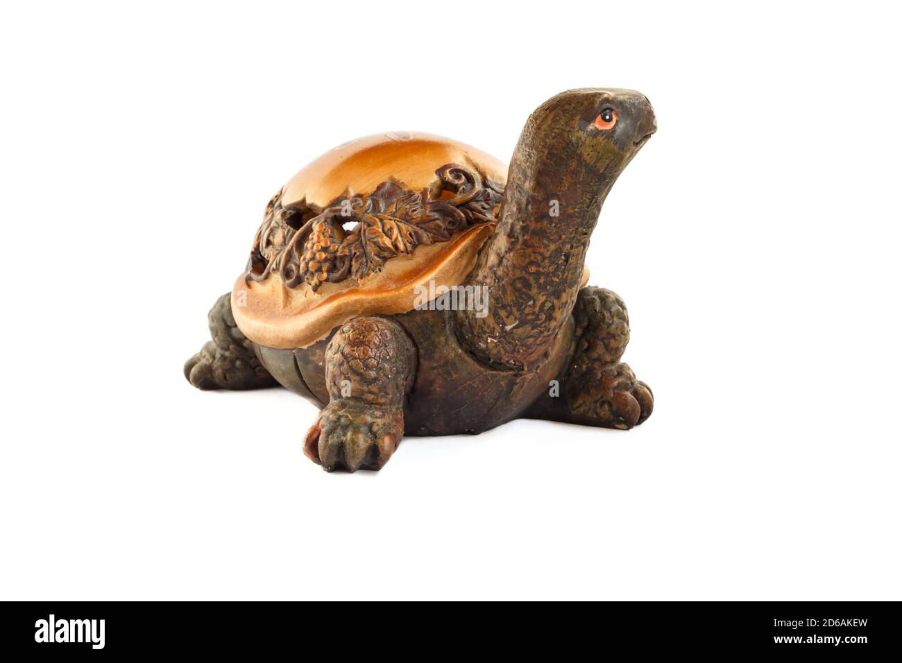 Wooden turtle figurine isolated on white background. Figurine of a turtle carved from wood. Stock Photo