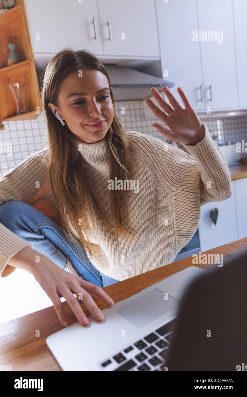 Woman having a video chat on her laptop at home Stock Photo