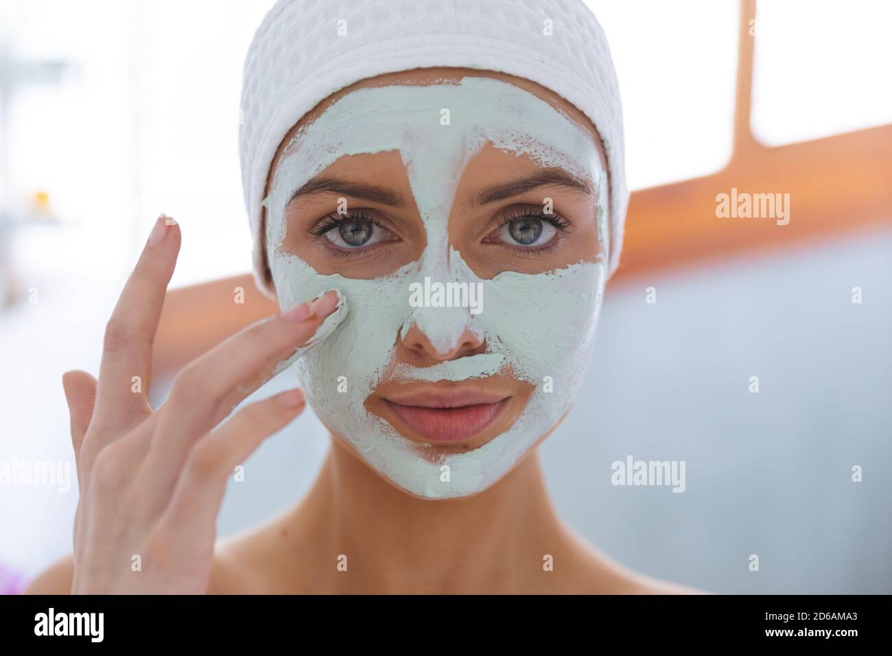 Portrait of woman applying face pack in bathroom Stock Photo