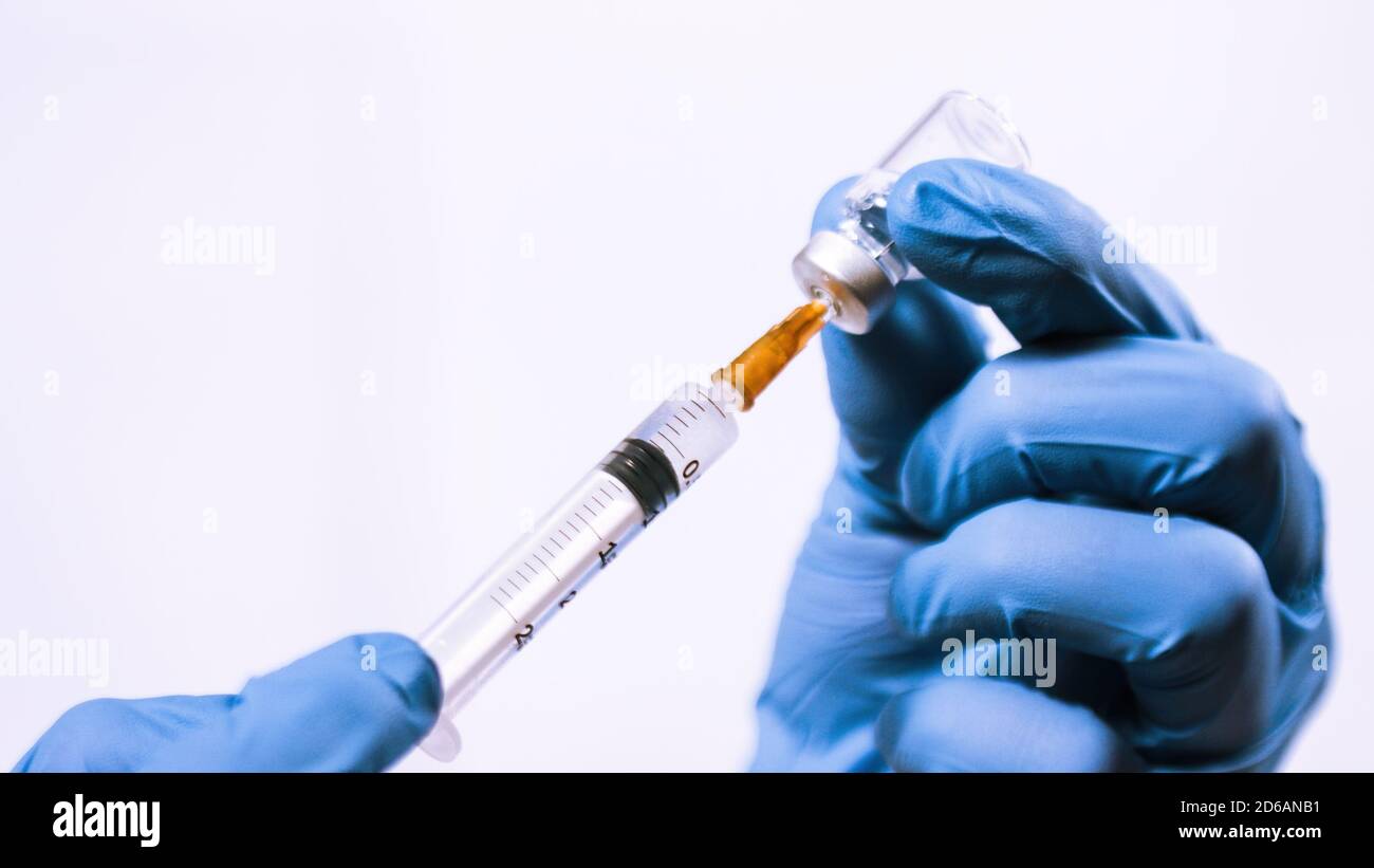 Coronavirus vaccine vial and syringe getting filled for injection Stock ...