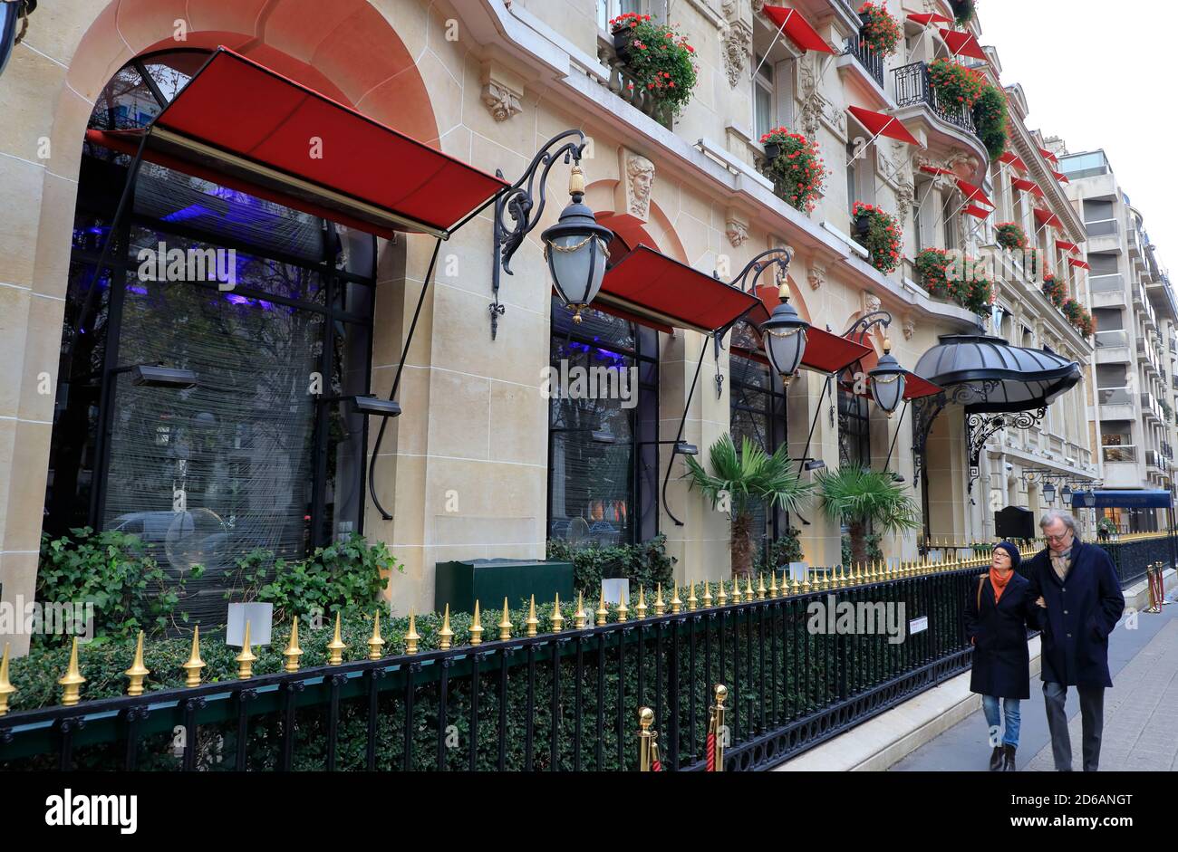 Exterior view of Hotel Plaza Athénée the historic landmark hotel in Avenue Montaigne with pedestrians.Paris.France Stock Photo