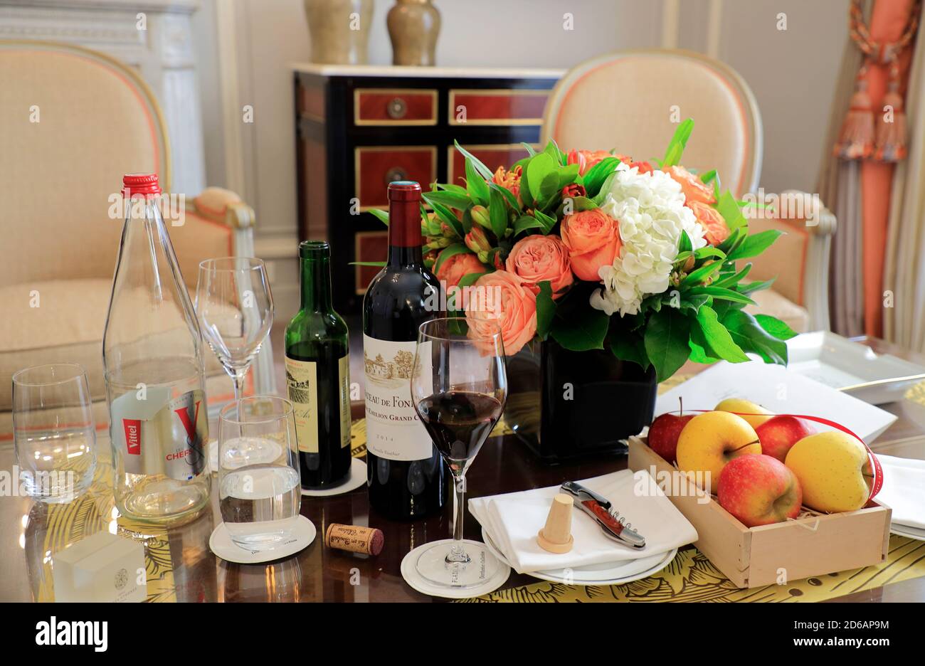Flowers fruits and wines on the table in the living room of suite in Hotel Plaza Athénée, the historic landmark hotel in Avenue Montaigne.Paris.France Stock Photo