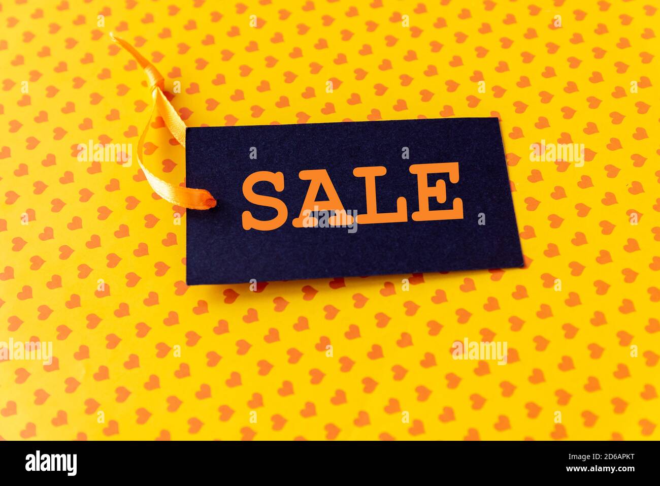 Sale label decorative ribbon on wrapping paper Stock Photo - Alamy