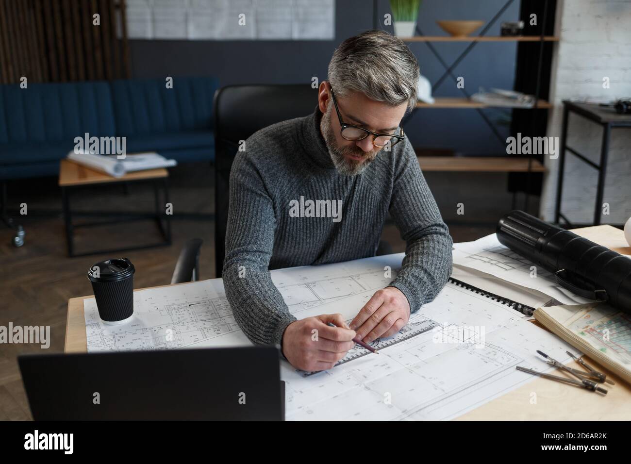 Interior designer working in office with blueprints.Engineer inspect ...