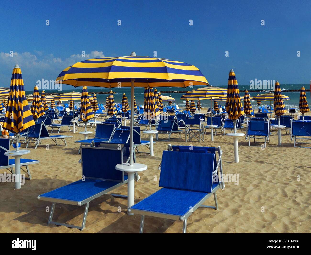 Sun beds and umbrellas on one of the private beaches in Pesaro. Europe, Italy, Marche, Pesaro. Stock Photo