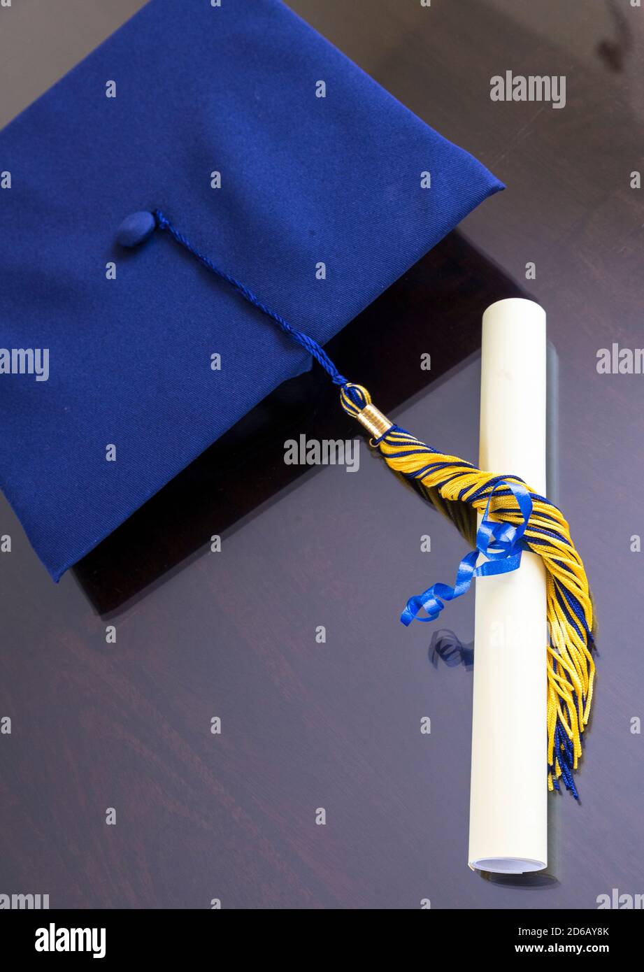 Graduation cap with rolled diploma on brown background Stock Photo - Alamy