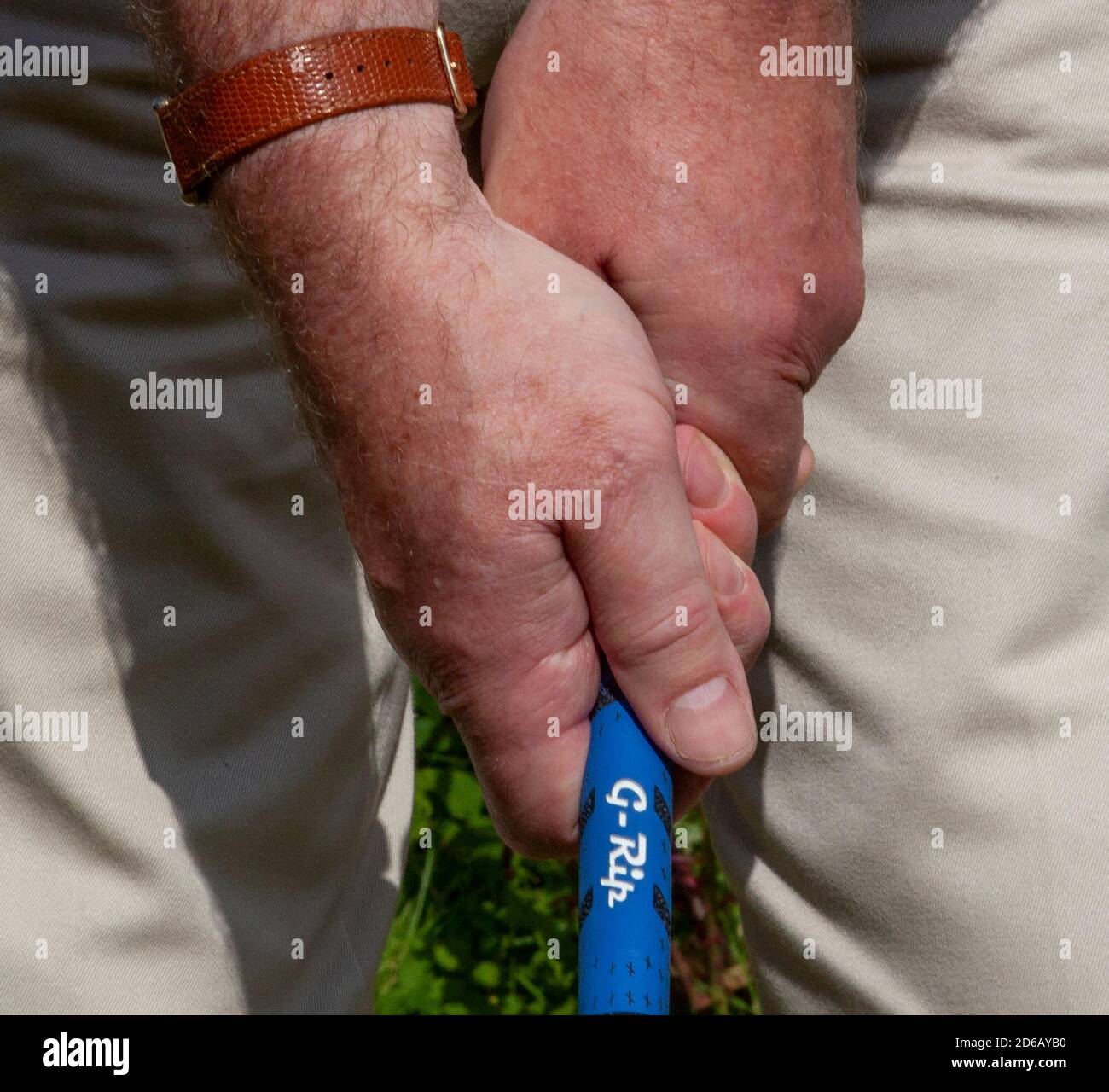 Golf grip; man holding golf club with overlapping or Vardon grip Stock