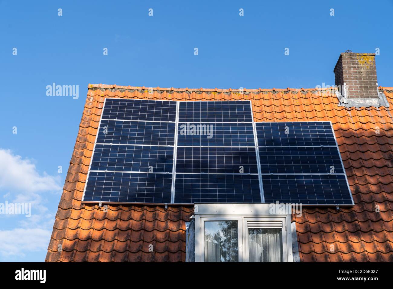 Roof with red roof tiles and solar panels for making renewable energy ...