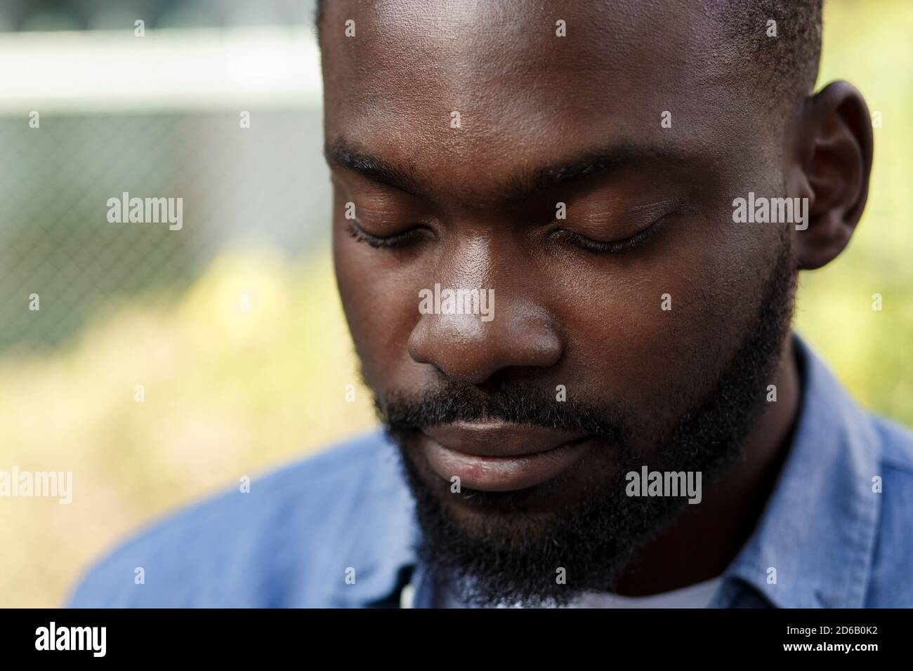 Close up portrait of serious African American man with closed eyes ...