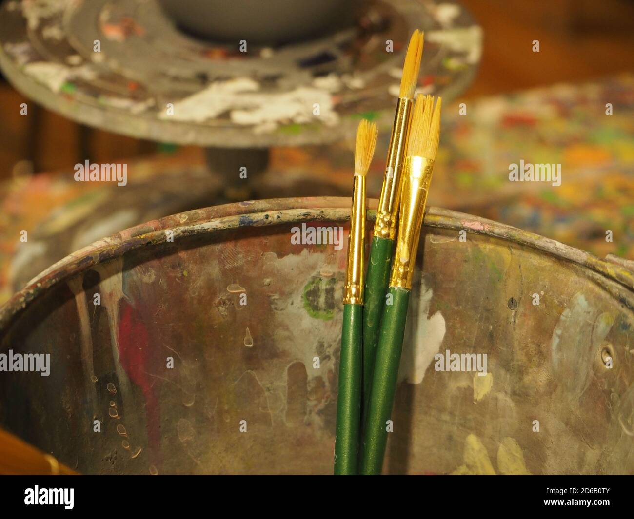 Clean paintbrushes with a messy background. This was taken at a DIY art