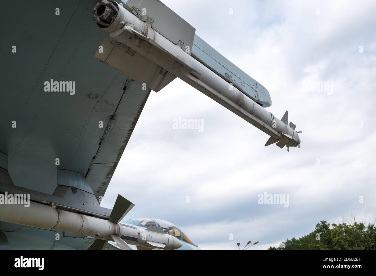 Two air-to-air missiles are suspended under the wing of the aircraft. Fragment of the plane Stock Photo