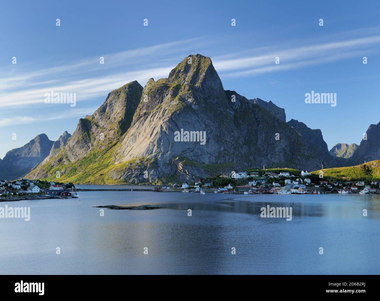 View To Reine On Lofoten Island Moskenesoy In The Late Afternoon Sun On A Sunny Summer Day With A Clear Blue Sky And A Few Clouds Stock Photo