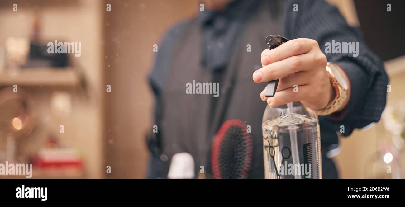 hairdresser, barber in an apron on a light background Stock Photo - Alamy
