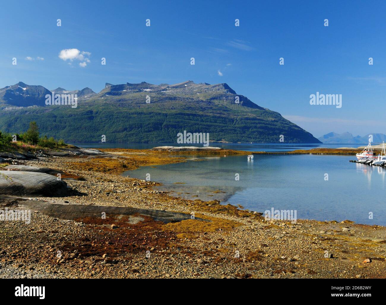 A beautiful inlet with crystal clear water and a boat hi-res stock ...