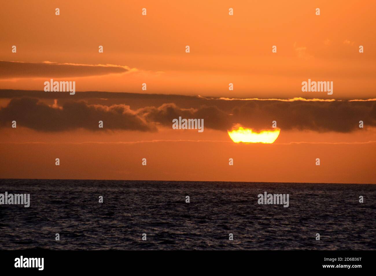 The Sun Setting in the Sea Stock Photo - Alamy