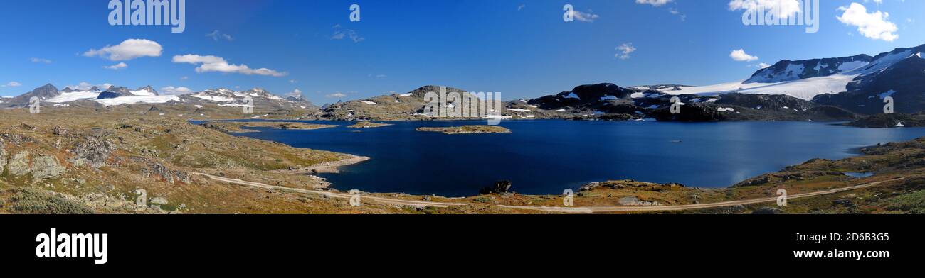 Panorama View Of Lakes And Glaciers In The Barren Landscape Of The Icefields Of Jotunheimen National Park On A Sunny Summer Day With A Clear Blue Sky Stock Photo