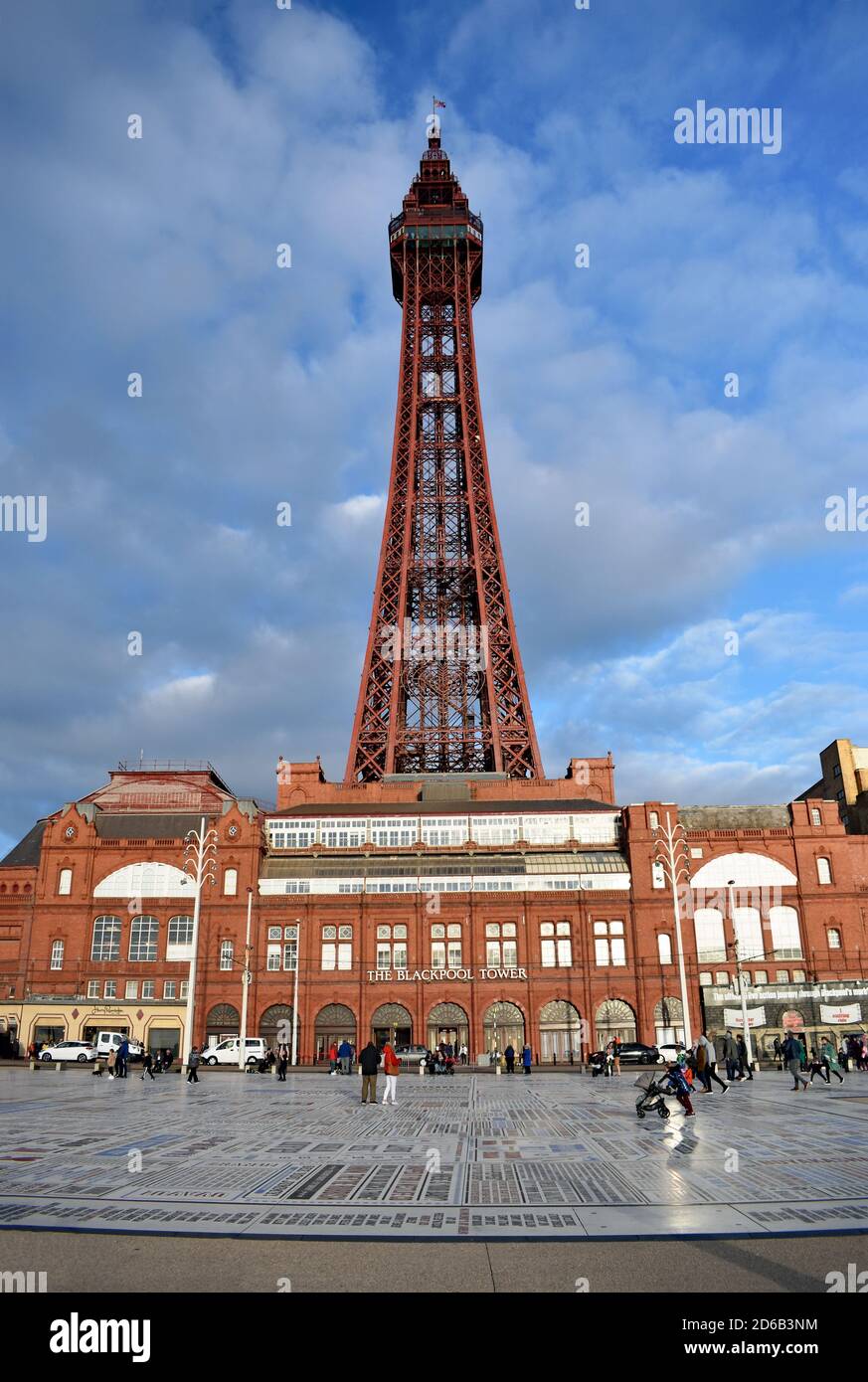 Looking towards the Blackpool Tower and victorian tower buildings, an entertainment complex. In front of the tower, Blackpool's Comedy Carpet is seen. Stock Photo