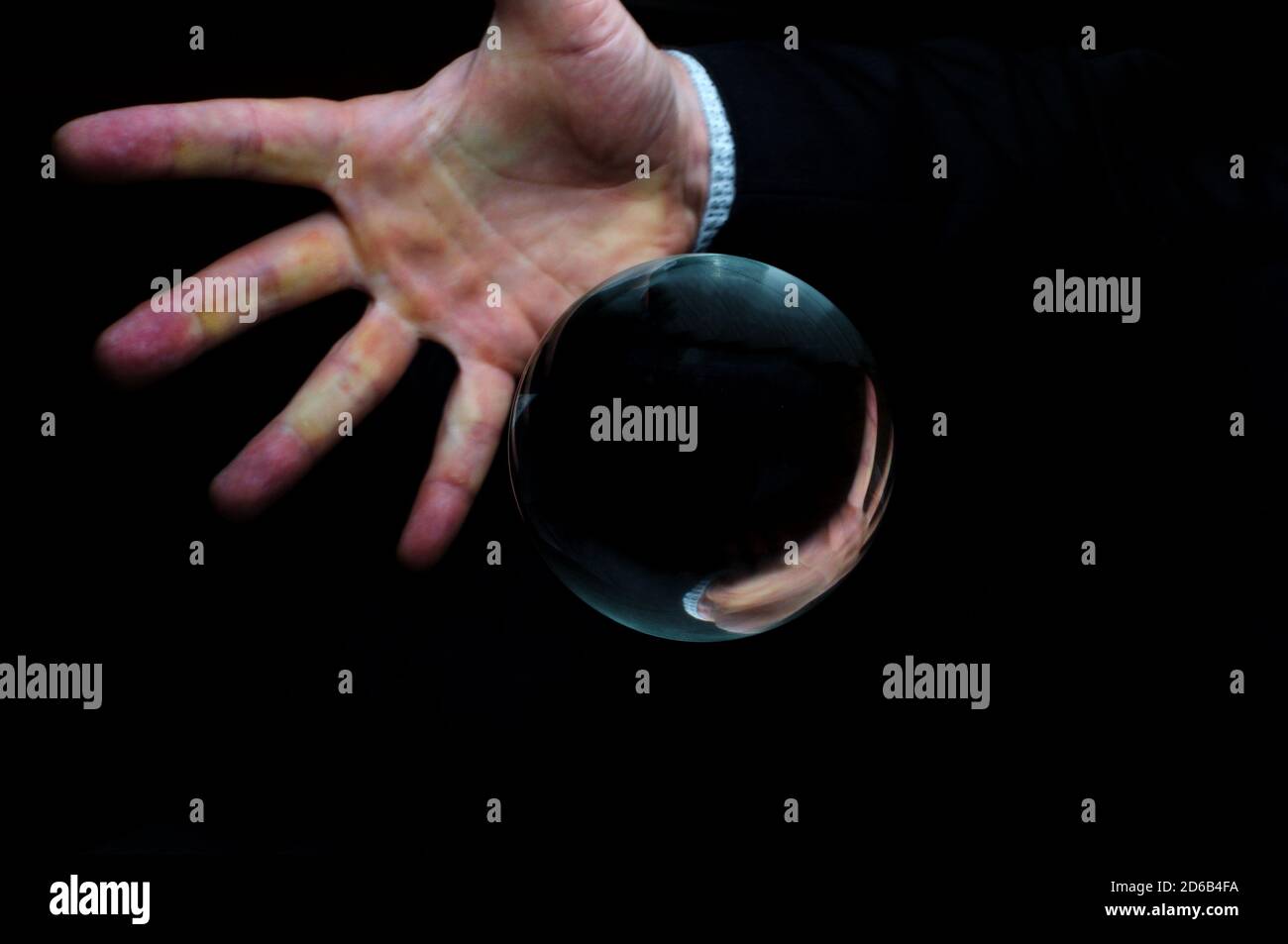 Holding magic crystal ball in fortune teller business background Stock ...