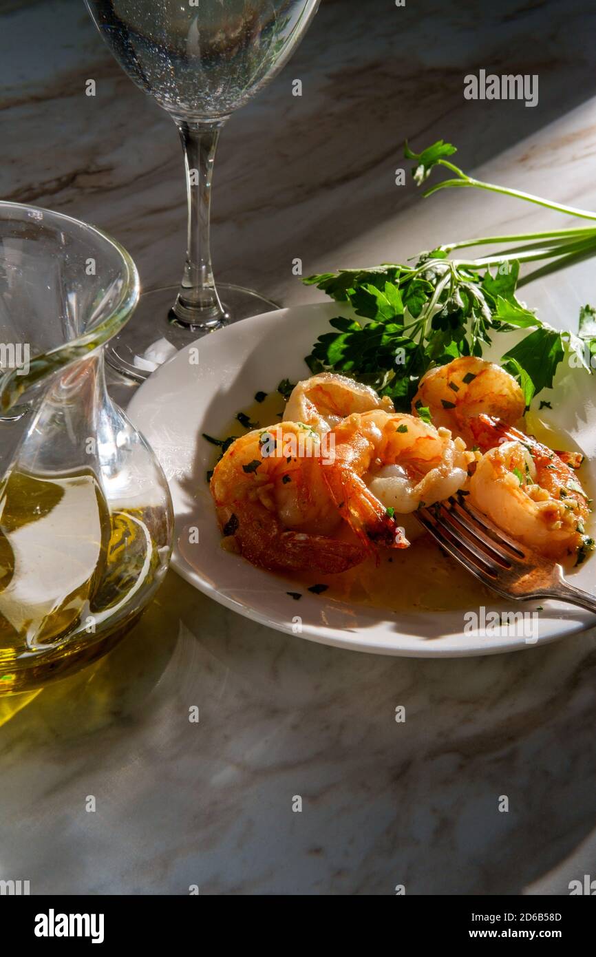 Portuguese dinner camarao ao alho e oleo garlic shrimp with dramatic sunlight Stock Photo