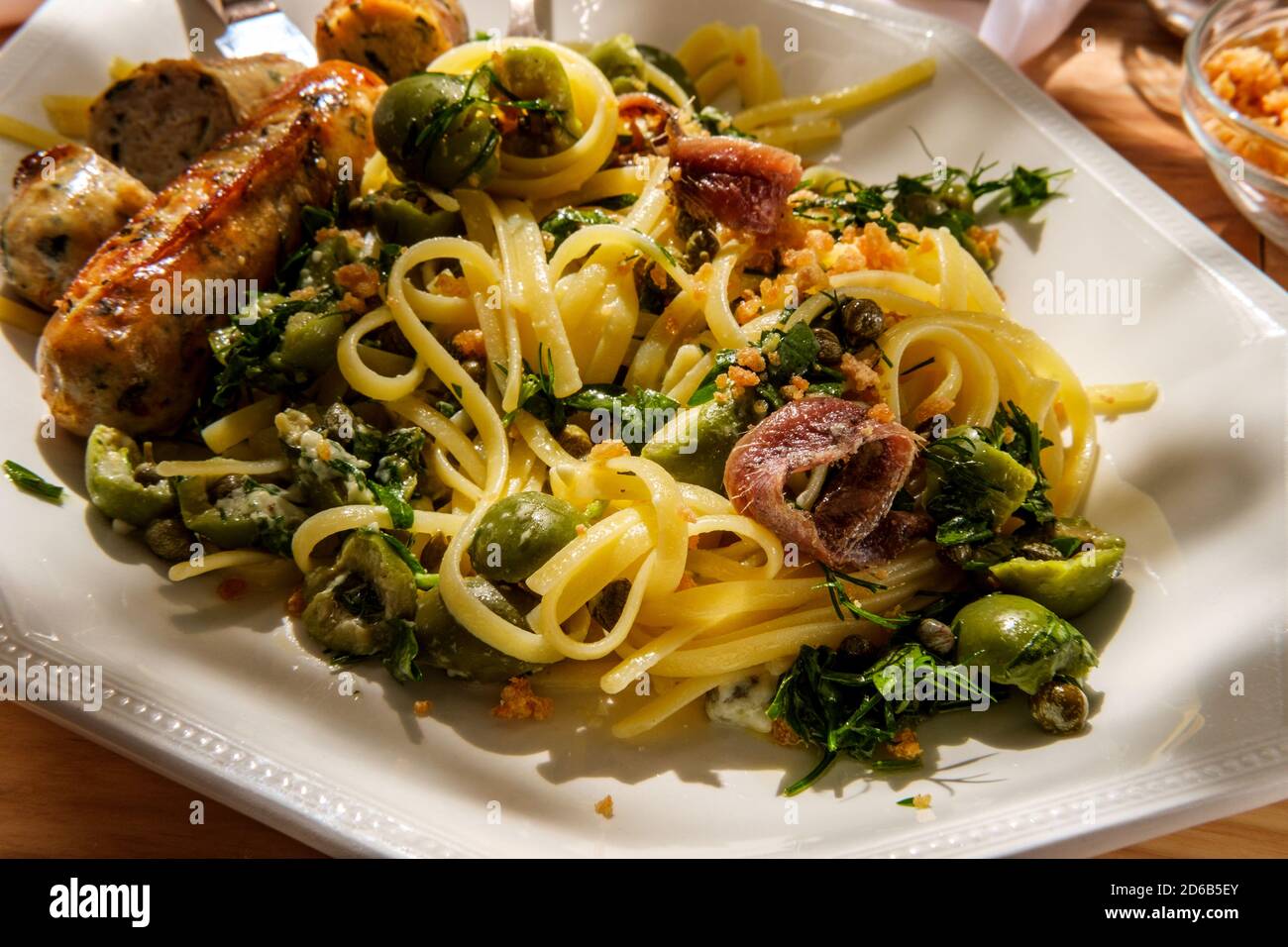 Italian chicken spinach sausage and linguine with herbed green castelvetrano olive sauce