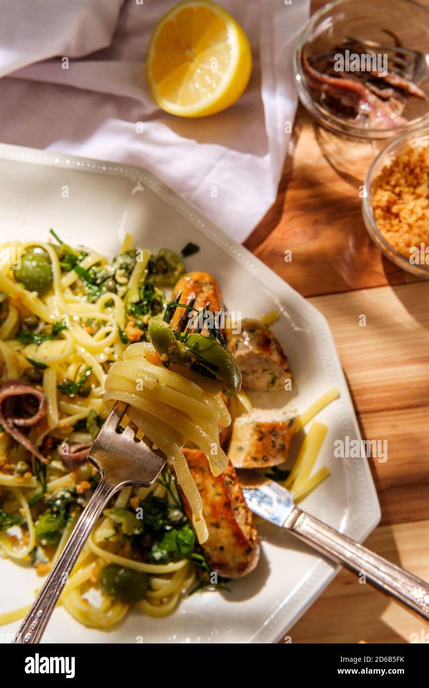 Italian chicken spinach sausage and linguine with herbed green castelvetrano olive sauce