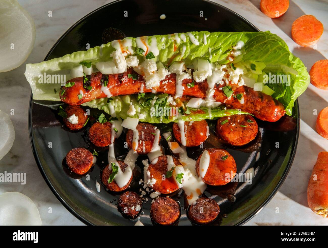 Fancy gourmet glutenfree lettuce wrap hot dog with carrots Stock Photo