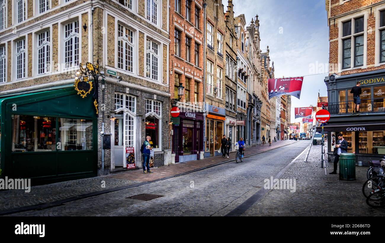 Early Morning activity on the normally busy Steenstraat in the historic city of Brugge in Belgium Stock Photo