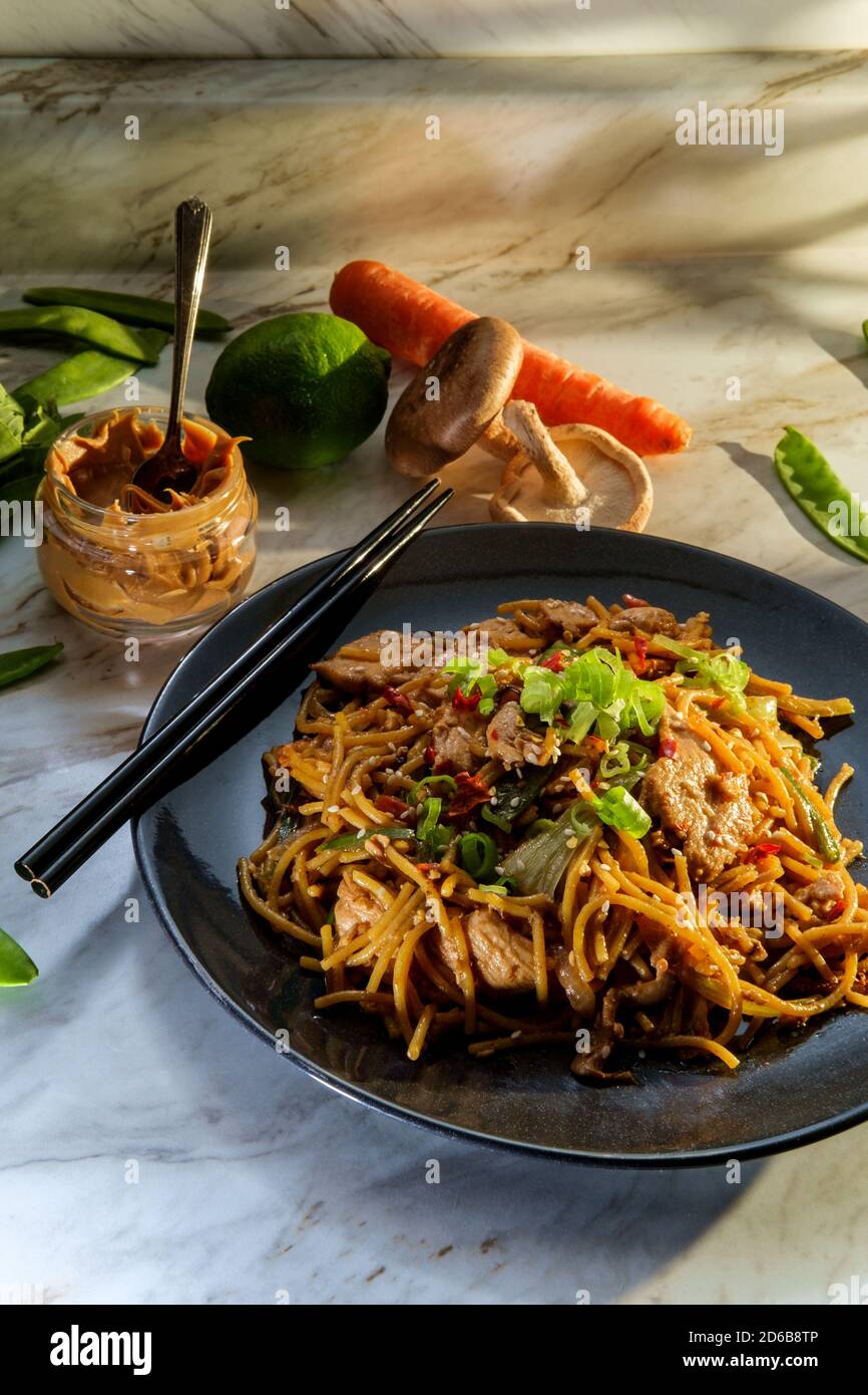 Spicy Thai chicken peanut butter lo mein noodles with sesame seeds