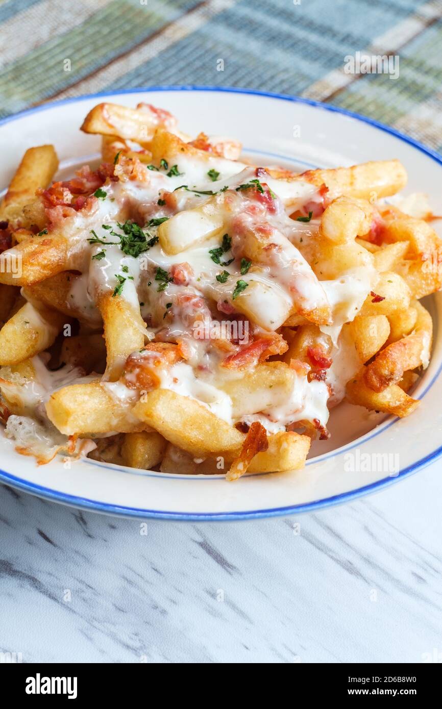 Crispy French fried potatoes loaded with bacon creamy ranch dressing and mozzarella cheese Stock Photo