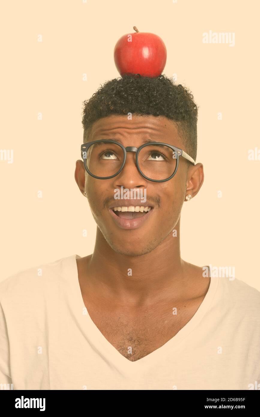 Young happy African man with apple on head Stock Photo - Alamy