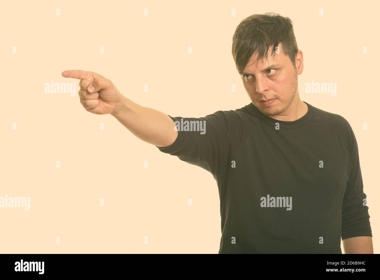 Studio shot of angry man pointing finger Stock Photo
