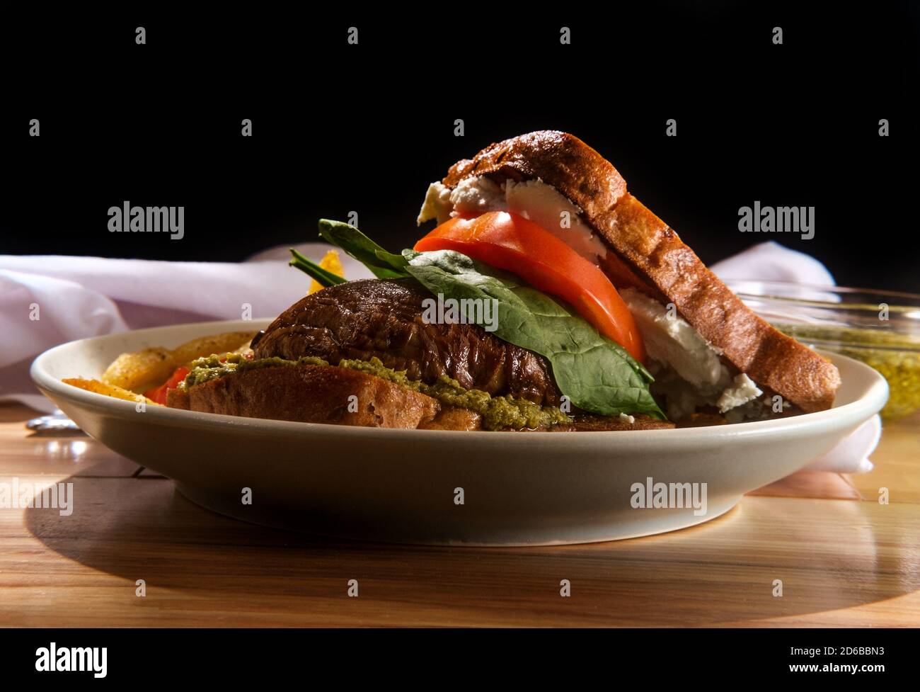 Portobello mushroom sandwich with goat cheese pesto and side of french fries Stock Photo Alamy