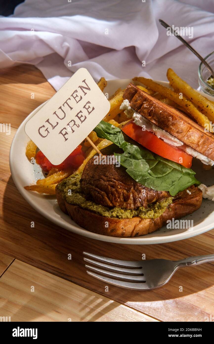 Portobello mushroom sandwich with goat cheese pesto and side of french fries Stock Photo Alamy