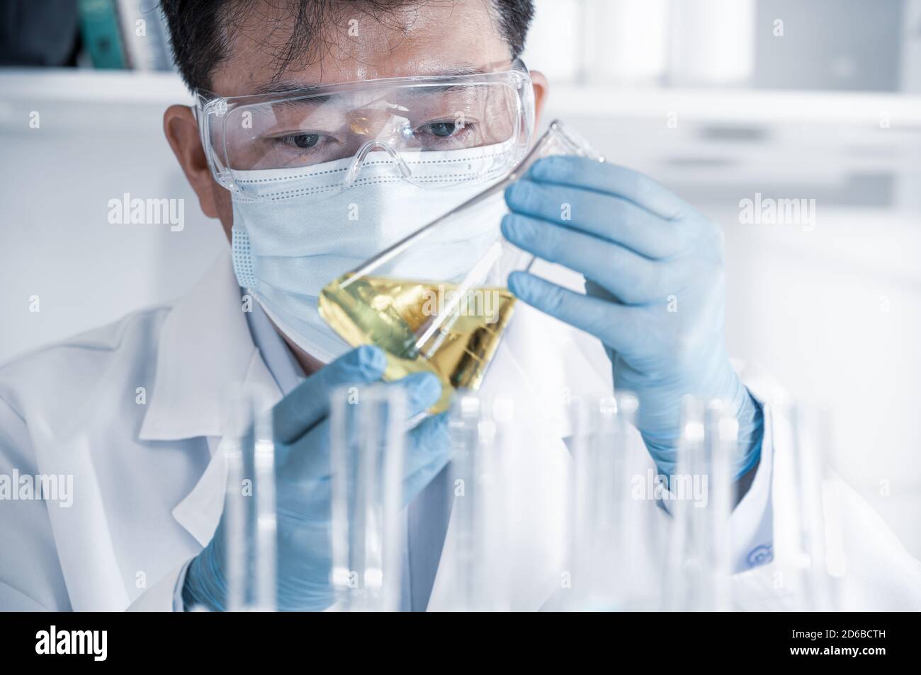 Asian male scientist working in a laboratory. Vaccine development concept. Stock Photo