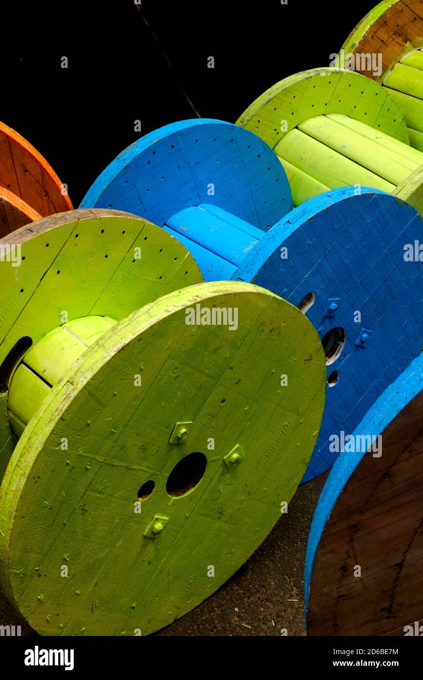 Wooden cable drums in different colours Stock Photo - Alamy