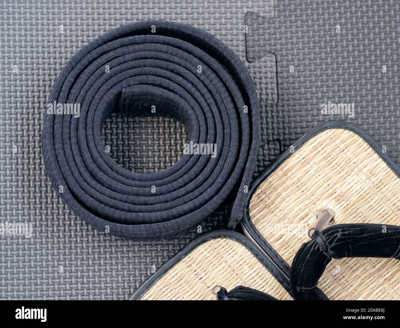 martial arts slippers and black belt on 