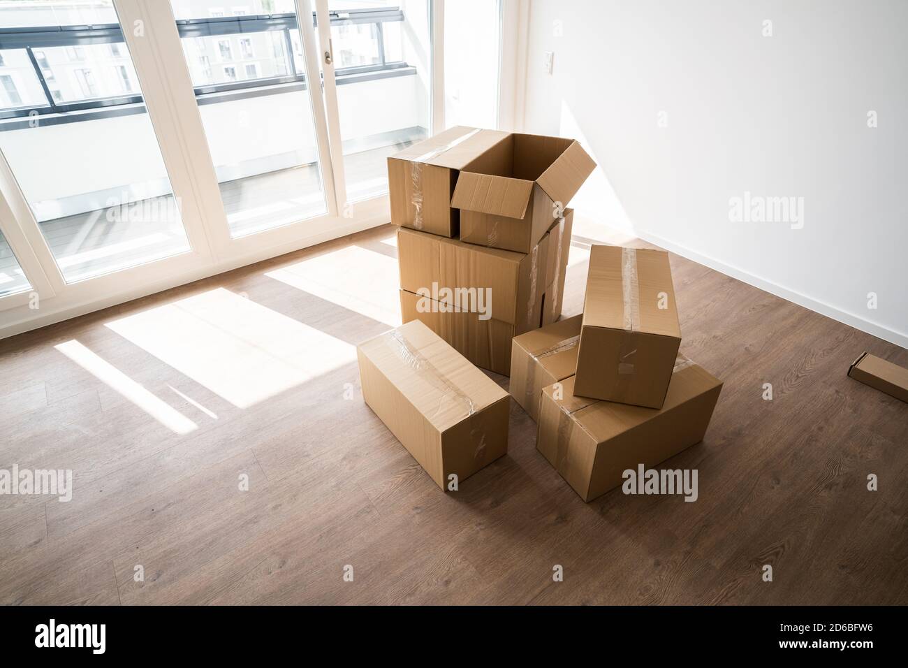 Empty Room With Moving Boxes Or Cartons Stock Photo