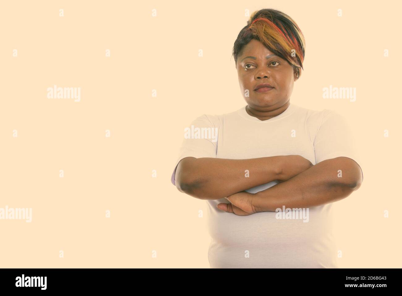 Studio shot of fat black African woman thinking with arms crossed ready ...