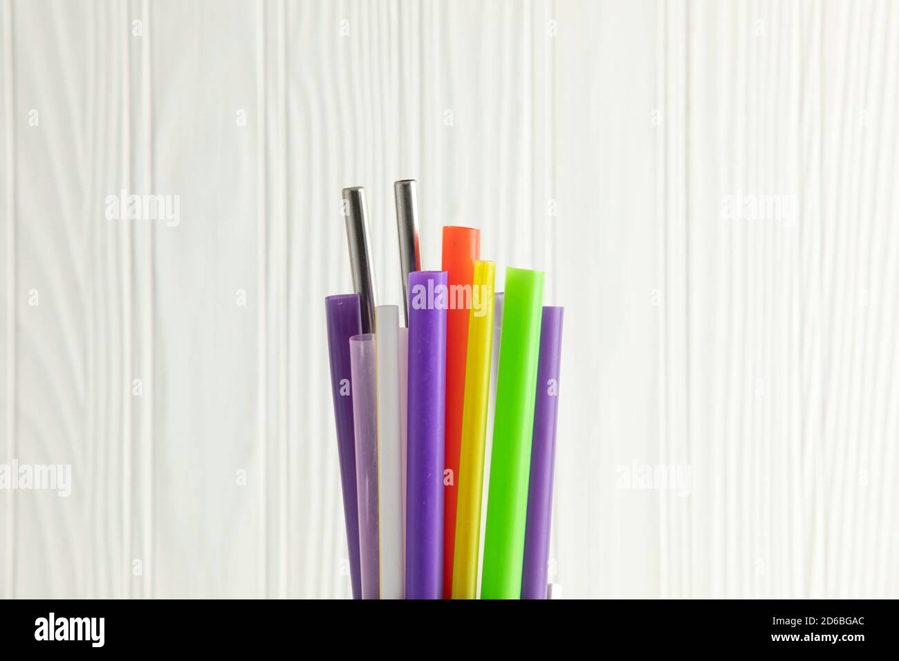 Bunch of colored plastic straws isolated on white background close up ...