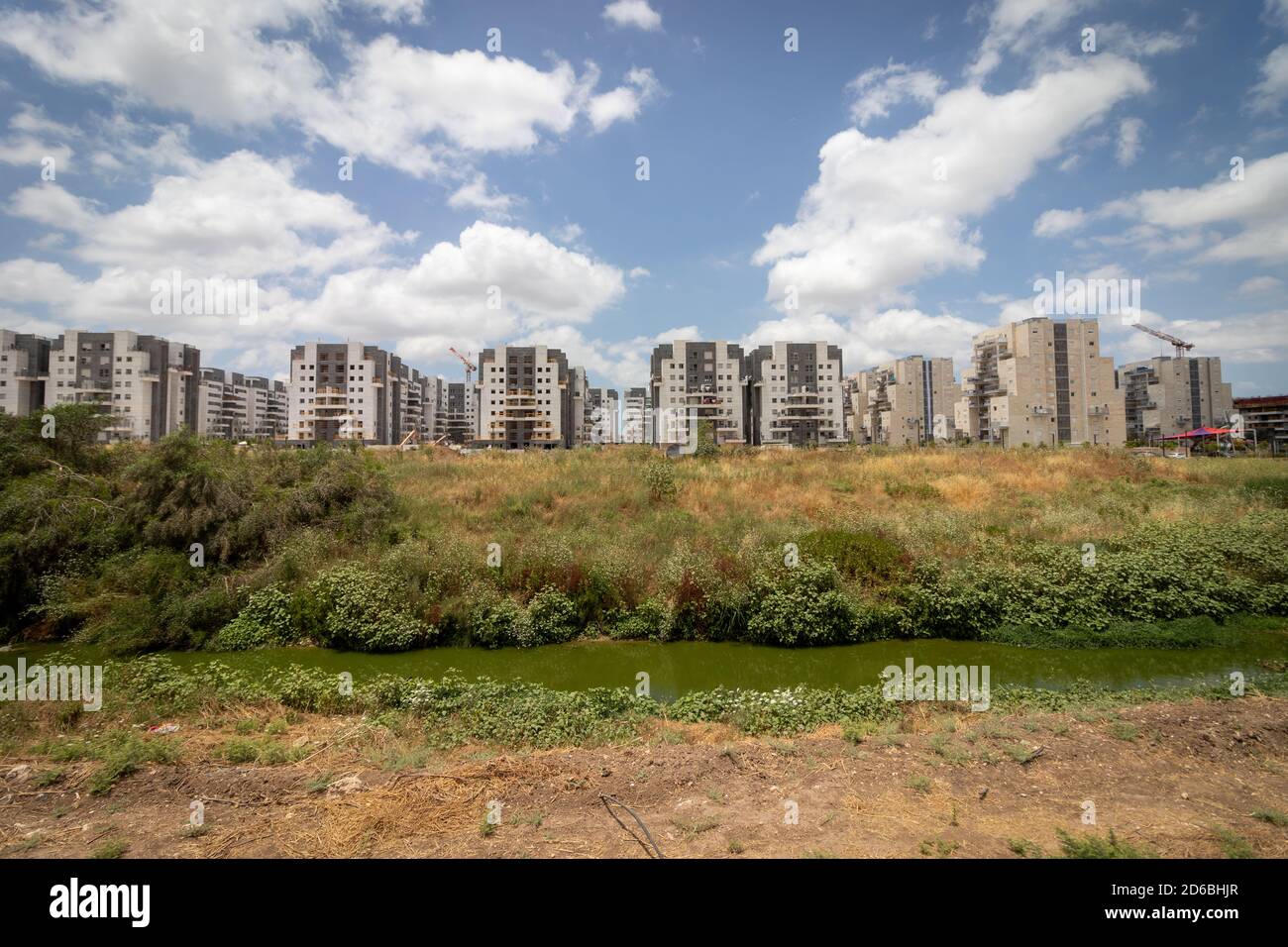 Ganei Ayalon neighborhood at the entrance to Moshav Ahisamakh and a stream that flows near the neighborhood, new buildings against a background of clo Stock Photo